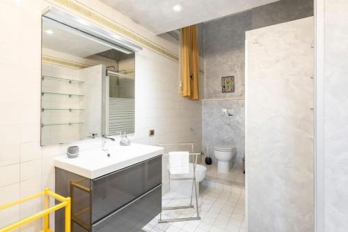 a bathroom with a sink and a toilet at Stunning Center Rome Apartment in Rome