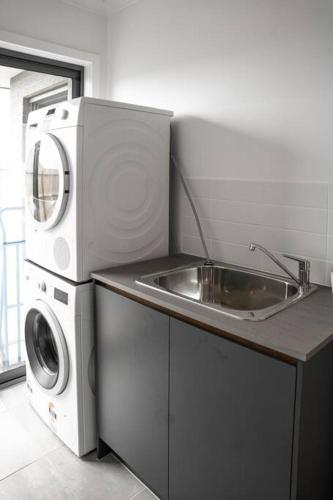 a kitchen with a washing machine and a sink at Sandy feet retreat in Peterborough
