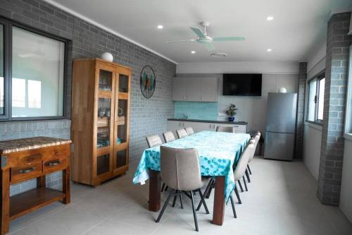 a kitchen with a table and chairs in a room at Sandy feet retreat in Peterborough