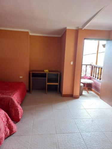 a bedroom with a bed and a table and a balcony at Monte Gocta in Valera