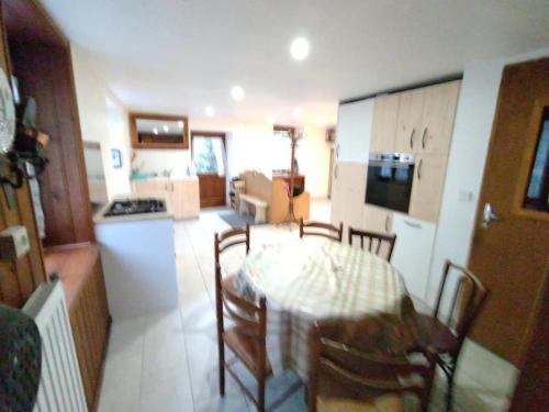 a kitchen and dining room with a table and chairs at Maison de village - montagne in Landry
