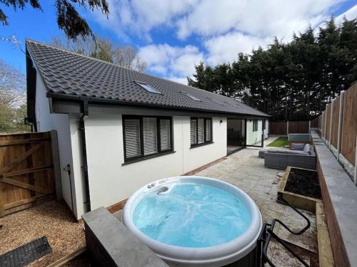 a bath tub in the backyard of a house at Rare Luxury Holiday Home with Hot-Tub in Belton