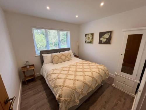 a bedroom with a bed and a window at Rare Luxury Holiday Home with Hot-Tub in Belton