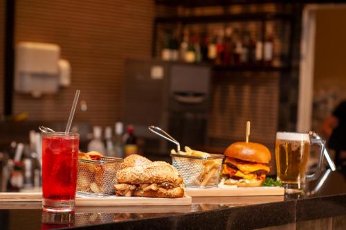 a table with two sandwiches and two glasses of drinks at DoubleTree by Hilton - Resort - Foz do Iguaçu in Foz do Iguaçu