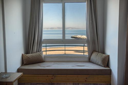 a window seat with a view of the beach at Palm Hotel Le Kram in Le Kram
