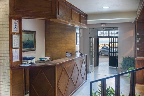 a lobby with a reception desk in a building at Palm Hotel Le Kram in Le Kram