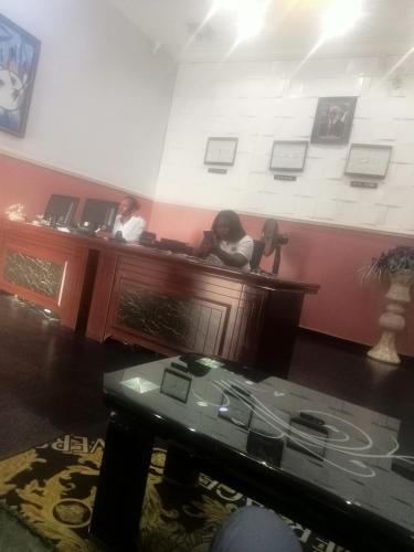two women sitting at a counter in a room at CRYSTAL SUITES in Akure