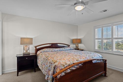 a bedroom with a bed and a nightstand and a window at 7019 - Sara's Sea Breeze by Resort Realty in Rodanthe