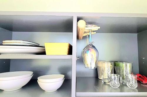 a shelf with bowls and plates and a vase at E7 9th floor in Yangyang