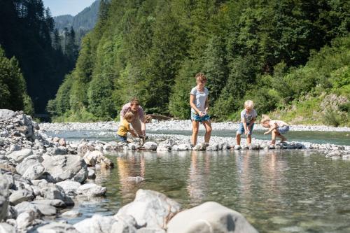 a group of people standing on rocks in a river at Haus Sonnberg in Mellau