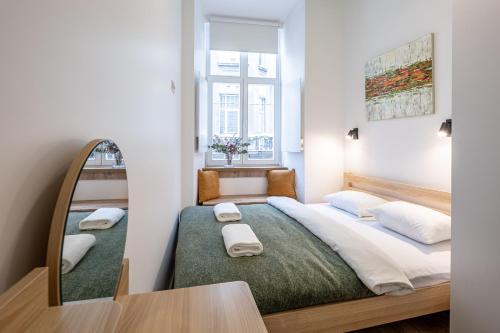 a bedroom with a large bed with a mirror at Apartments on Krakowska street in Lviv