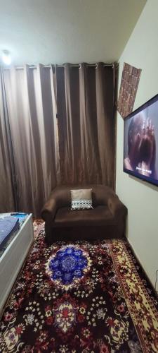 a living room with a couch and a rug at MAMA DELiGHT HOME in Abu Dhabi