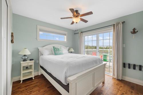 a bedroom with a bed and a ceiling fan at The Gables of PEI in Stanley Bridge