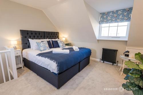a bedroom with a large bed in a attic at Stylish townhouse, Poole Quay, sleeps 6, garden - Gull House in Poole