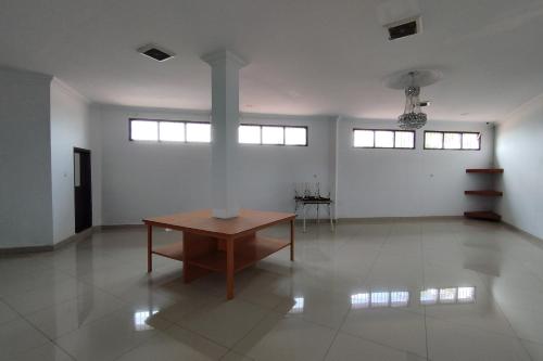 a large white room with a table in the middle at Rich Guesthouse in Paalmerah