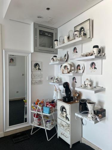 a room with shelves with dolls on the wall at برج داماك in Jeddah