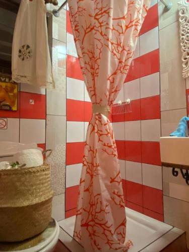 a pink shower curtain in a bathroom with a cake at Stratos ArtDeco House in Kalavasos
