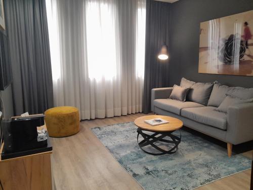 a living room with a couch and a table at Hotel Silken Amara Plaza in San Sebastián