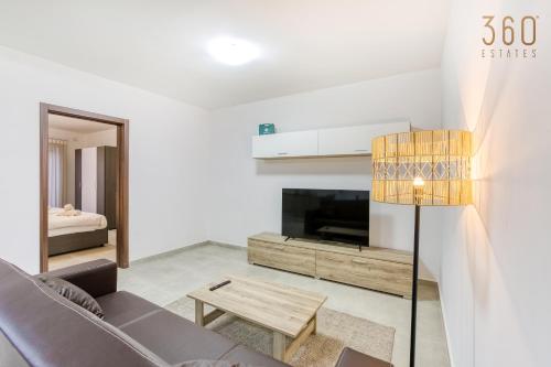 a living room with a couch and a tv at Beautiful 3-bed home with Greenery Views in Mgarr by 360 Estates in Mġarr