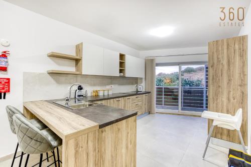 a kitchen with a sink and a large window at Beautiful 3-bed home with Greenery Views in Mgarr by 360 Estates in Mġarr
