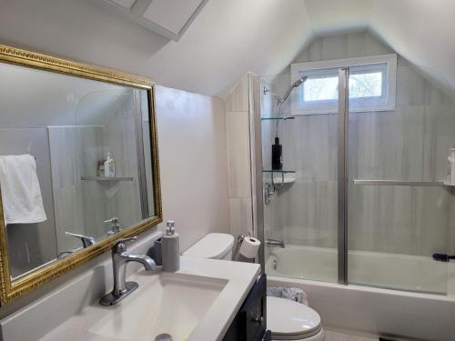 een badkamer met een wastafel, een douche en een toilet bij Brand new house with private bath in each room in West Seneca