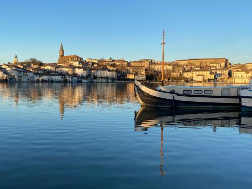 a boat is docked in the water in a harbor at Le Grand Bassin in Castelnaudary