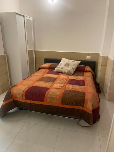 a bedroom with a bed with a pillow on it at case vacanze maglie centro in Maglie