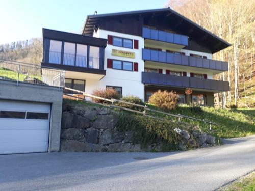 a house on a hill with a garage at Haus Sonnberg in Mellau
