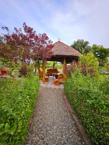 a gazebo with a bench and a table at Jungle Heritage in Paliā Kalān