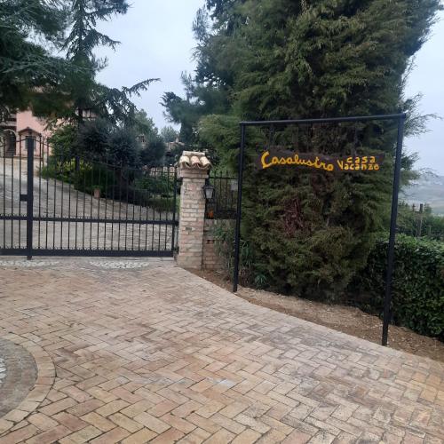 a black wrought iron gate with a sign on it at Casalustro in Citta' Sant'Angelo