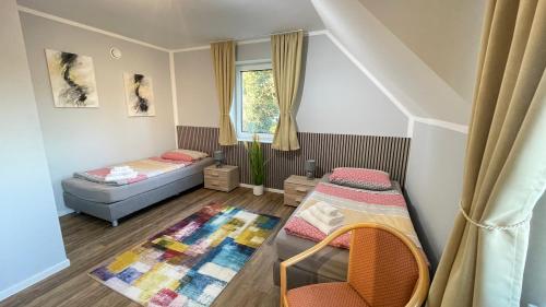 a small room with two beds and a window at Idyllisches Ferienhaus in Hatten in Hatten