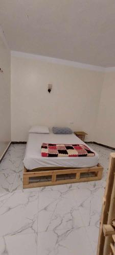 a bedroom with a bed in the corner of a room at Green Beach Camp & Hotel in Nuweiba
