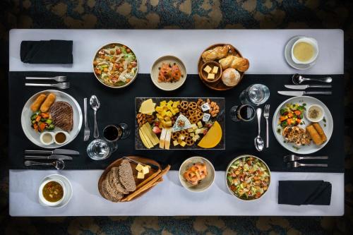 a table with many different dishes of food on it at M/S Esmeralda Nile Cruise - 4 or 7 Nights From Luxor each Monday and 03 Nights From Aswan each Friday in Luxor