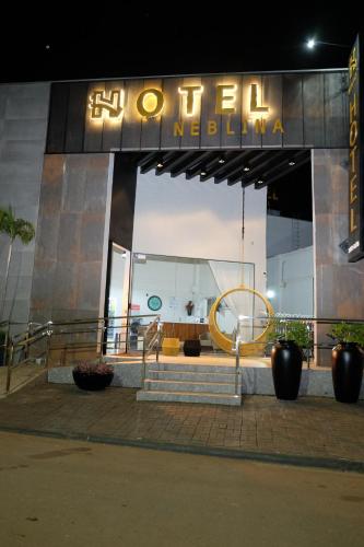 a hotel with a sign on the front of it at Hotel Neblina in Araguaína