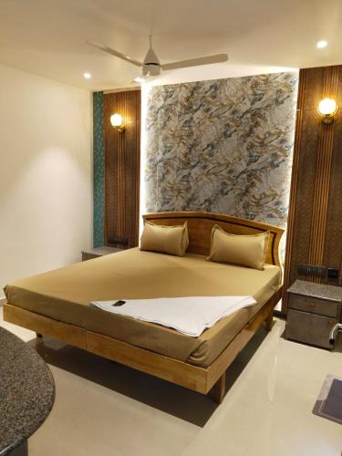 a bedroom with a bed and a stone wall at Hotel AK International - Chennai in Chennai