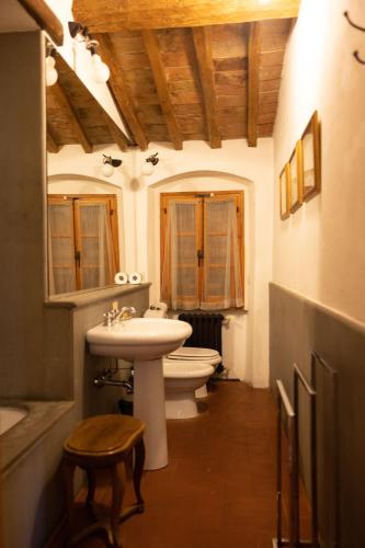 a bathroom with two toilets and a sink and a sink at Castello di Bibbione in San Casciano in Val di Pesa