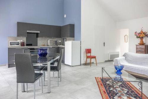 a kitchen and living room with a table and chairs at Les Augustins *T4* in Orléans