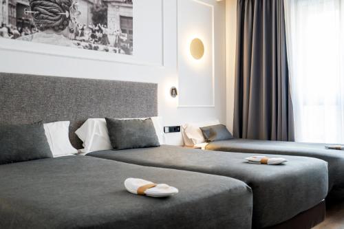 Postel nebo postele na pokoji v ubytování Hotel Conqueridor