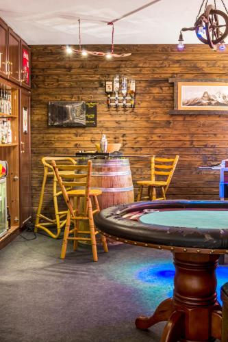 a bar with a ping pong table in a room at Doug's Mountain Getaway - 'Top Two Floors' in Fulpmes