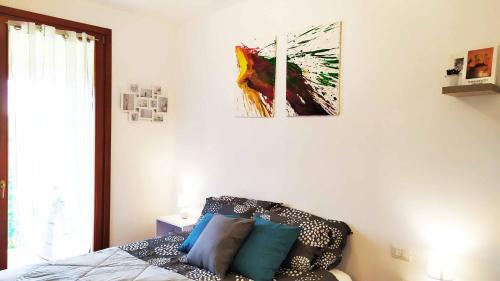 a bedroom with a bed and a painting on the wall at Casa Modigliani - Tra Arte e Natura 