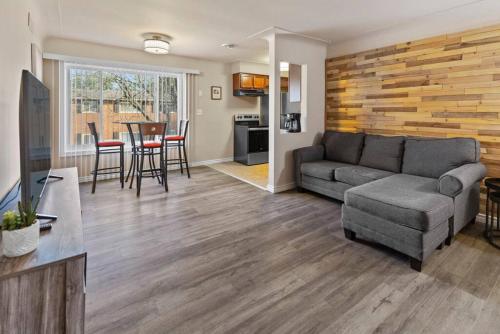 a living room with a couch and a table at Modern Cozy 2b apt in Shelby Twp in Shelby