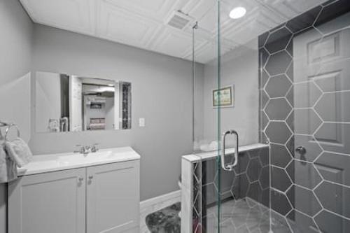 a bathroom with a shower and a sink at Urban Elegance Retreat in Downtown Rochester in Rochester