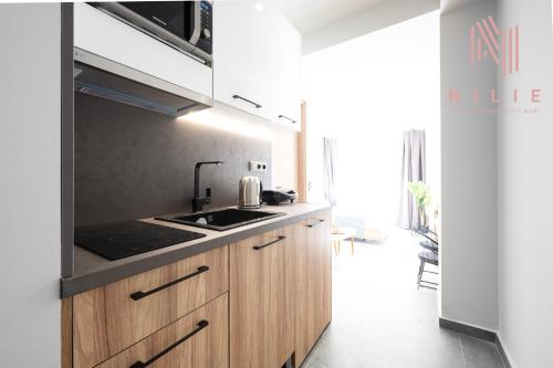 a kitchen with a sink and a stove top oven at Pantheon, Nilie Hospitality MGMT in Thessaloniki