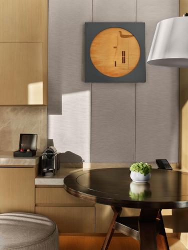 a dining room with a table and a kitchen at Hilton Shanghai Songjiang Guangfulin in Songjiang