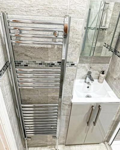 a bathroom with a sink and a shower at Town Centre Apartment Harrogate in Harrogate