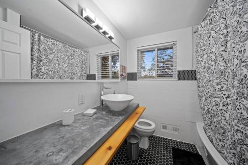 a white bathroom with a sink and a toilet at Birmingham Urban Retreat 2BR Cozy Haven in Birmingham