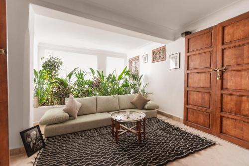 a living room with a couch and a table at Riad N'S in Marrakesh