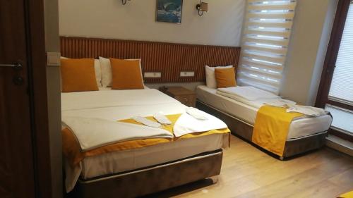 a bedroom with two beds and a window at Mr Lion Kumkapı Otel in Istanbul