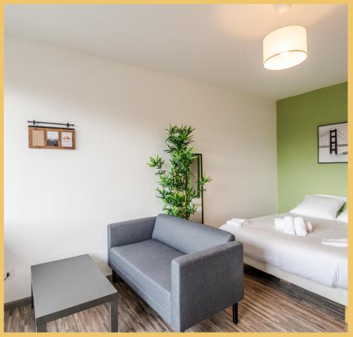 une chambre d'hôtel avec un lit et une chaise dans l'établissement Studio I Paisible I Annemasse, à Annemasse
