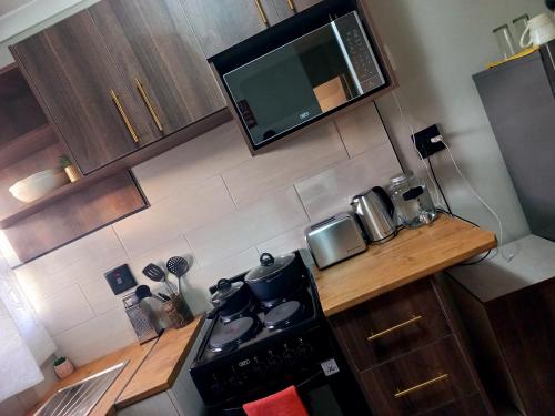 an overhead view of a kitchen with a stove and microwave at TALITHA'S SELF-CATERING ACCOMONDATION in Walvis Bay